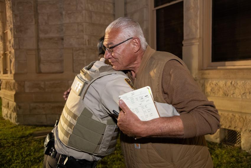 Gabriel Garza, left, augmentee with the sheriff’s office, congratulates, Sheriff Joe Frank Martinez, right,  after the final vote counts for the night were announced around 10pm at Val Verde County Courthouse on election day on Tuesday, Nov. 5, 2024 in Del Rio, Texas. Martinez was in the lead ahead of his opponent Rogelio “Roger” Hernandez 7,926 votes to 6,033.