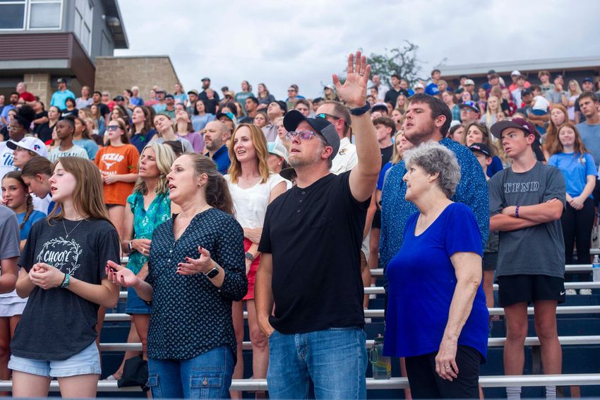 People worpship during a Kerr County Blessing at Antler Stadium on Wendsday July 9, 2025 in Kerrville, Texas.